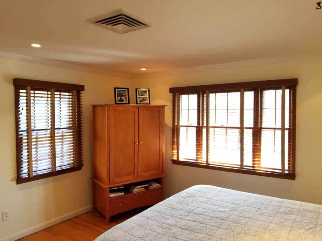 master bedroom with wooden blinds.