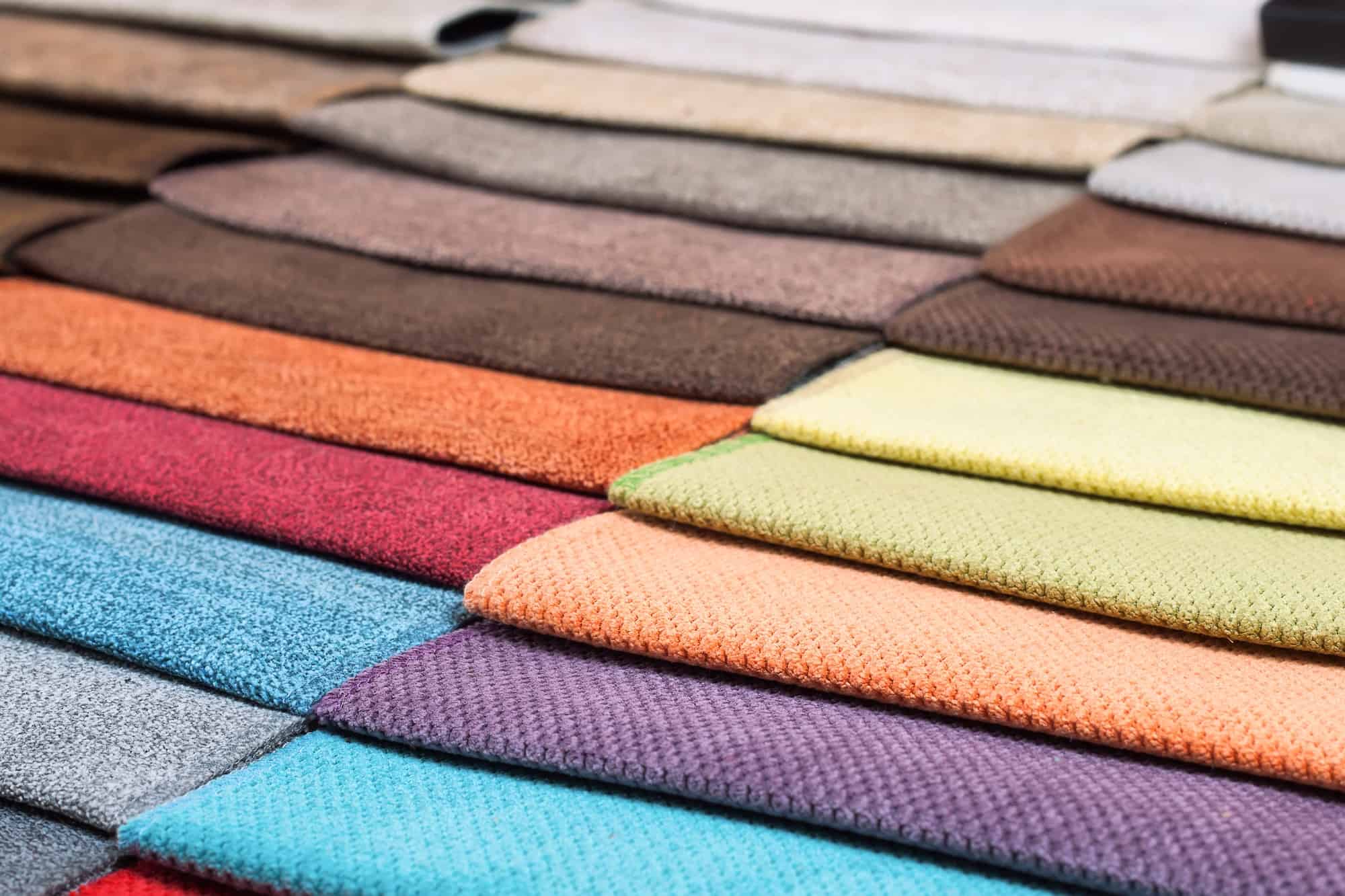 Color samples of the upholstery fabric in the assortment. palette of fabrics of various colors